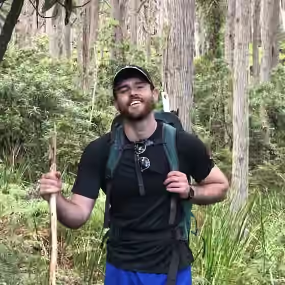 Sam Penny hiking in a forest
